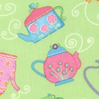 Tossed Colorful Teapots on Green