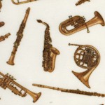 Tossed Brass and Woodwind Musical Instruments on Cream